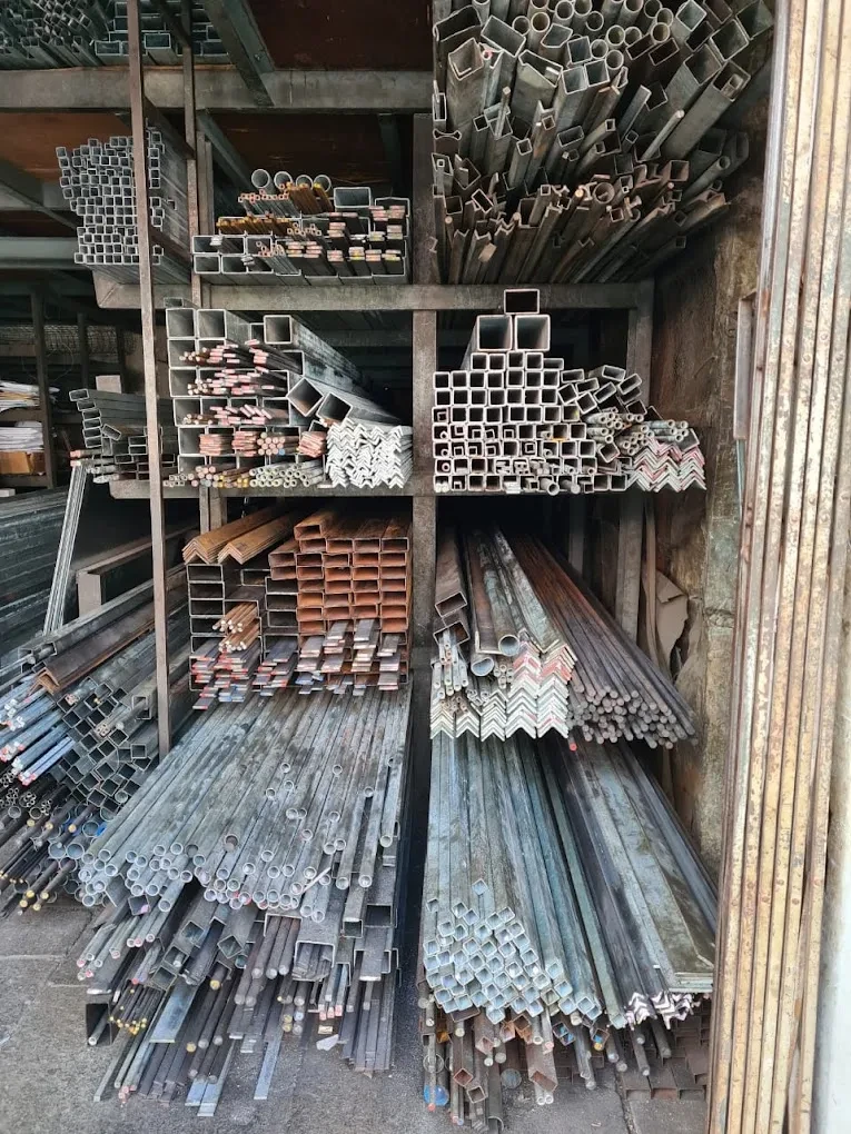 Shelves stocked with square tubes, angles, flat bars and pipes